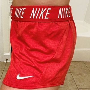 Red Nike training shorts white logo on band